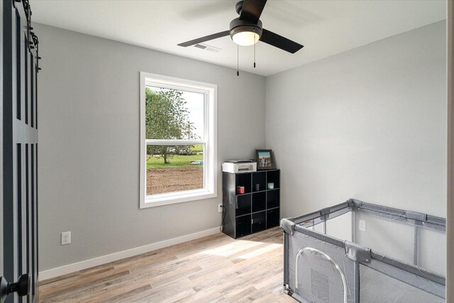 bedroom with visible vents, ceiling fan, light wood-type flooring, and baseboards