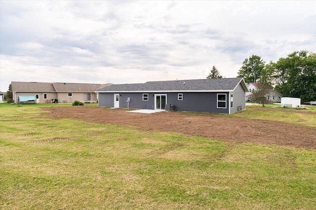 rear view of property with a lawn, cooling unit, and a patio