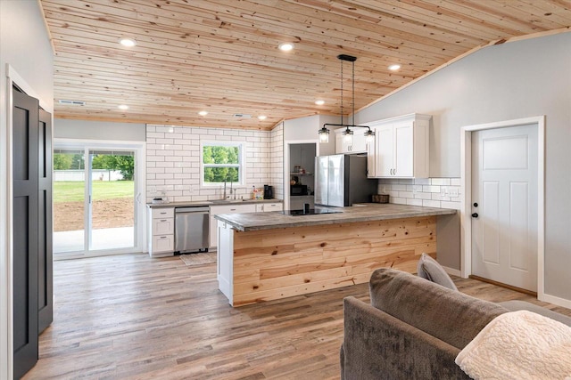 kitchen featuring appliances with stainless steel finishes, wood ceiling, kitchen peninsula, white cabinetry, and lofted ceiling