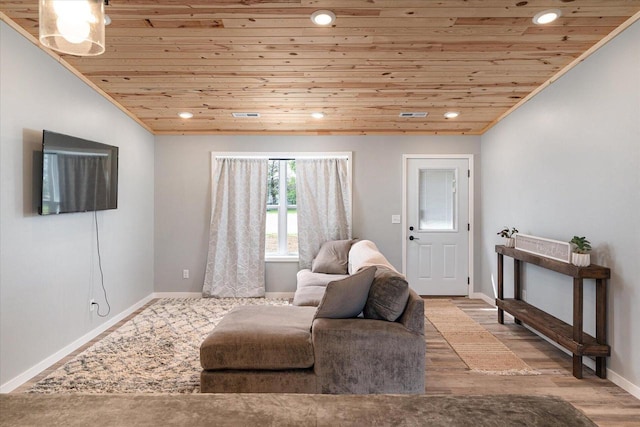 living room featuring recessed lighting, wood ceiling, and baseboards