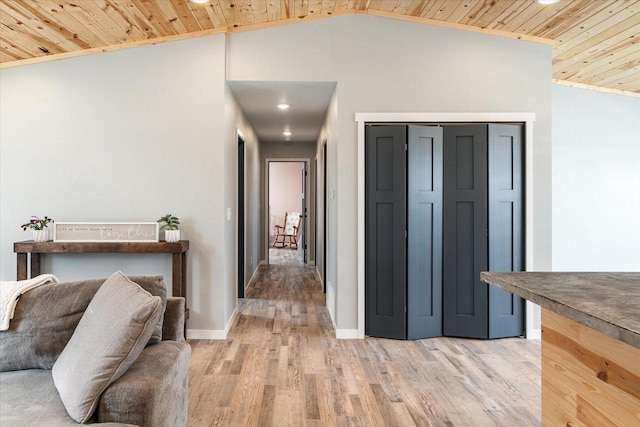 hallway with vaulted ceiling, wood ceiling, light wood-style floors, and baseboards