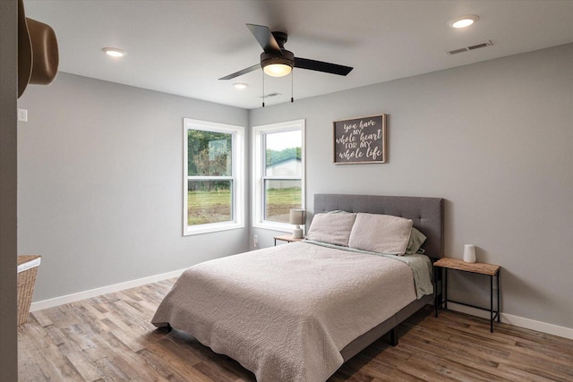 bedroom featuring recessed lighting, wood finished floors, visible vents, and baseboards