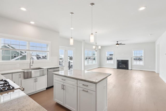 521 N Stone Ridge Dr, Lake Geneva, WI 53147 - kitchen featuring dishwasher, ceiling fan, recessed lighting, light stone countertops, and white cabinets