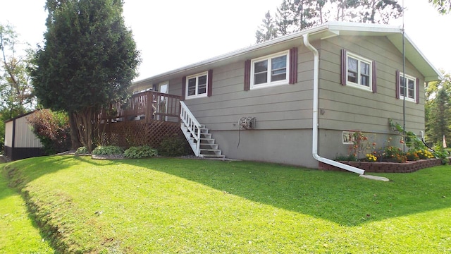 view of home's exterior featuring a lawn and a wooden deck