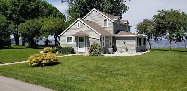 view of front of home featuring a front lawn and central AC