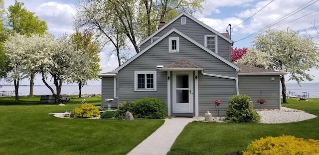 view of front of property with a front yard and a water view