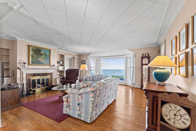 3790 Pau Ko Tuk Ln, Oshkosh, WI 54902 - living area featuring ornamental molding, wood finished floors, built in features, a fireplace with flush hearth, and a water view