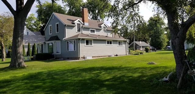 rear view of house with a lawn