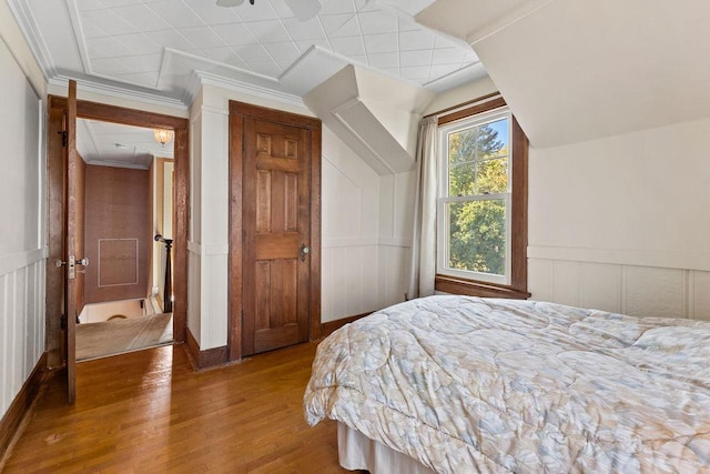 3790 Pau Ko Tuk Ln, Oshkosh, WI 54902 - bedroom featuring wood finished floors, a decorative wall, and a wainscoted wall