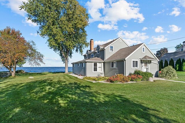 3790 Pau Ko Tuk Ln, Oshkosh, WI 54902 - view of property exterior with a water view, a yard, and a chimney