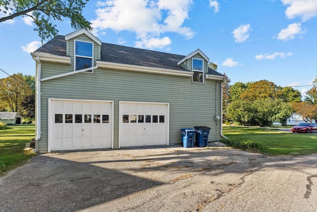 3790 Pau Ko Tuk Ln, Oshkosh, WI 54902 - view of side of home with roof with shingles, a garage, and a yard