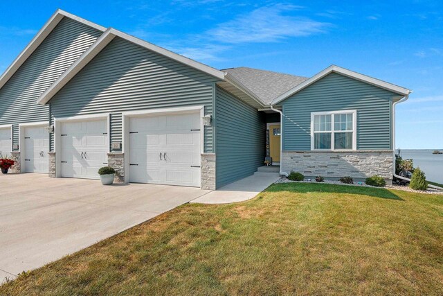 view of front of house featuring a garage and a front lawn