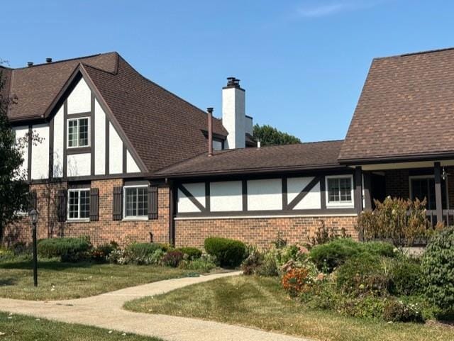 rear view of property with a lawn