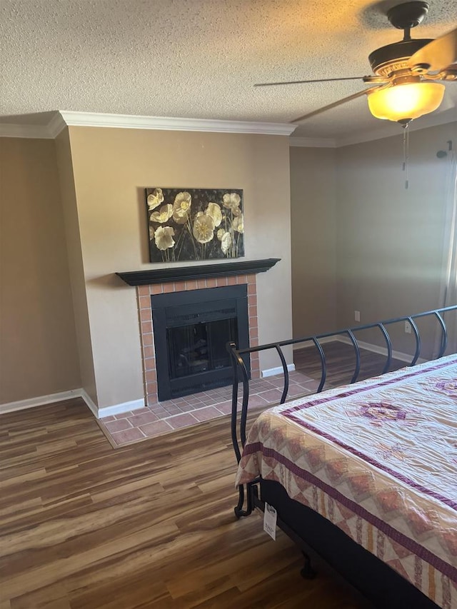 bedroom featuring hardwood / wood-style floors, ornamental molding, a textured ceiling, and ceiling fan