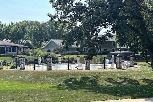 view of property's community with a yard and a swimming pool