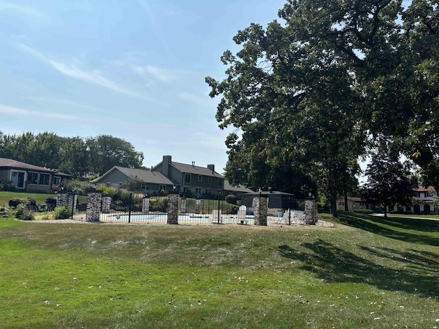 view of property's community with a yard and a swimming pool