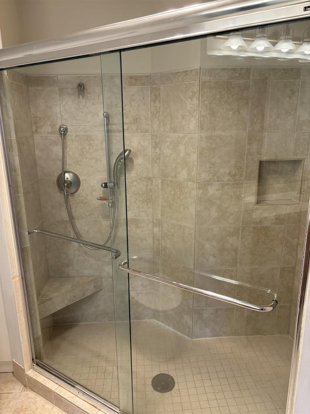 bathroom featuring a shower with door and tile patterned flooring