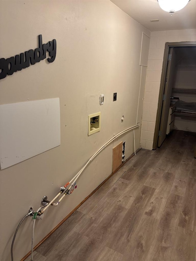 clothes washing area with gas dryer hookup, hardwood / wood-style floors, hookup for a washing machine, and electric dryer hookup