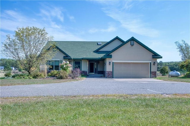 9018N Anderson Rd, Hayward, WI 54843 - view of front facade with driveway, a garage, a shingled roof, and a front yard