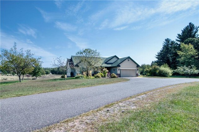 view of front of home with a front lawn and a garage