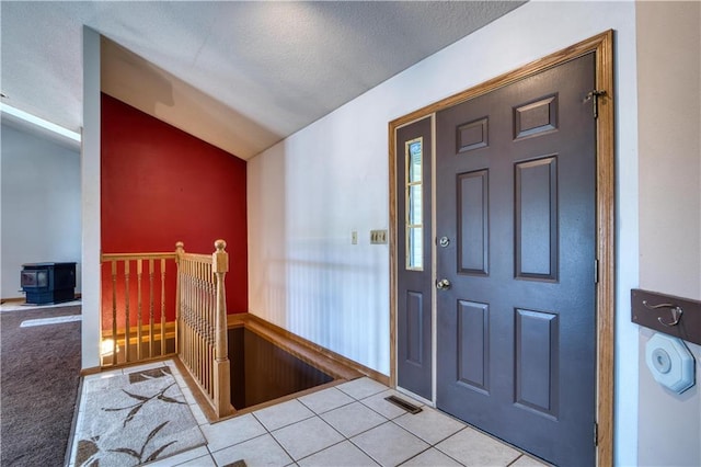 9018N Anderson Rd, Hayward, WI 54843 - tiled foyer with lofted ceiling and a wood stove