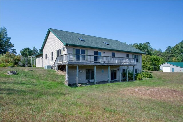 back of property featuring a wooden deck and a yard