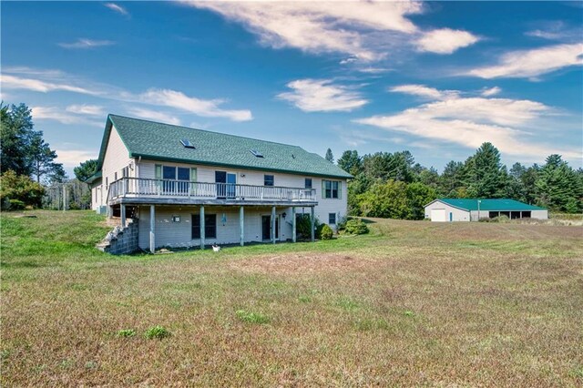 back of house with a wooden deck and a yard