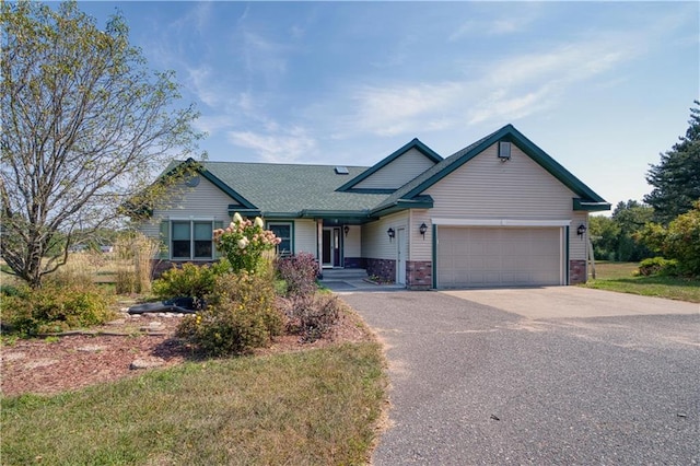 9018N Anderson Rd, Hayward, WI 54843 - view of front facade with asphalt driveway, an attached garage, and a shingled roof