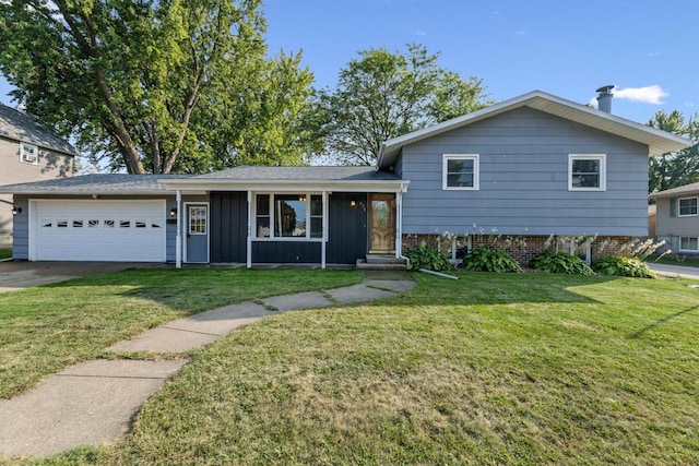 split level home featuring a garage and a front lawn