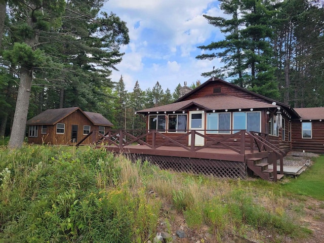 rear view of property featuring a deck