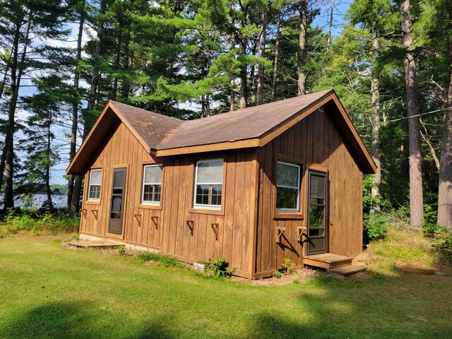 view of outbuilding featuring a lawn