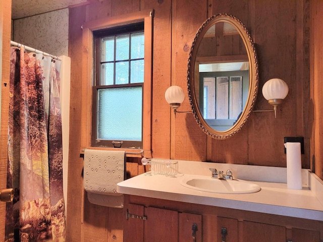 bathroom featuring wood walls and vanity