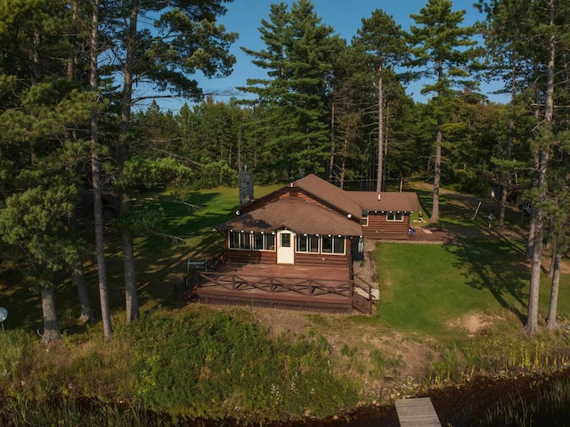 back of property featuring a yard and a deck