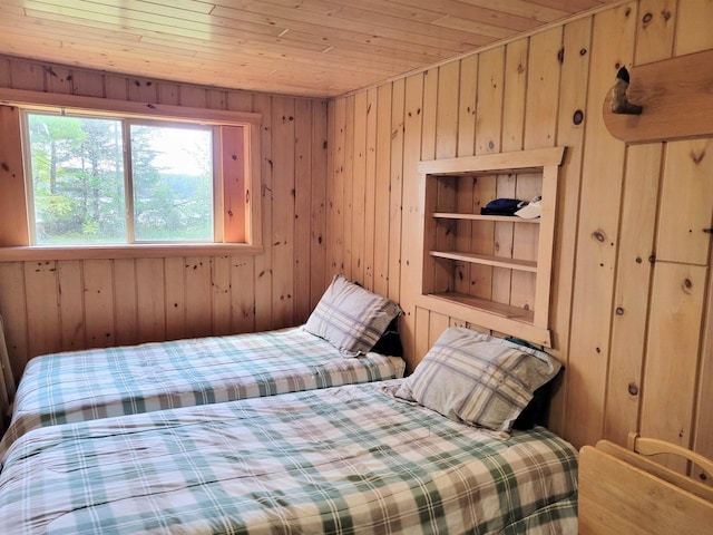 bedroom featuring wooden walls and wooden ceiling