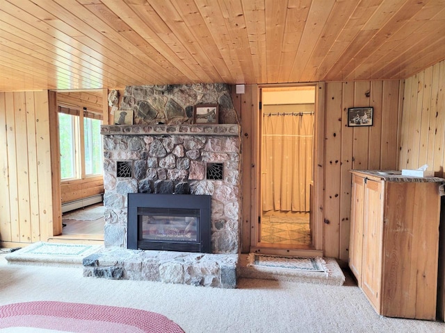 carpeted living room with wood ceiling, a baseboard radiator, wood walls, and a fireplace