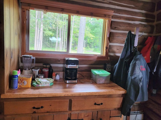 kitchen with plenty of natural light, butcher block counters, and wooden walls