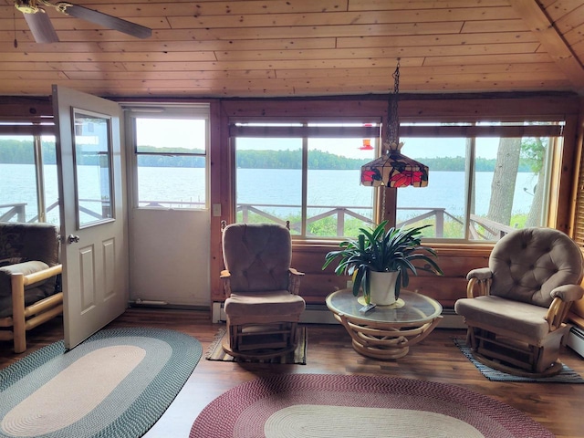 sunroom / solarium with a wealth of natural light, ceiling fan, and a water view