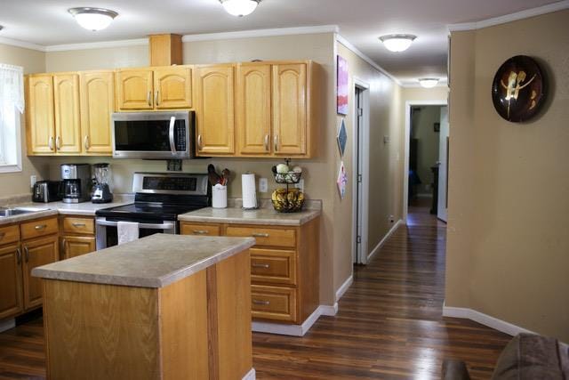 kitchen with ornamental molding, a center island, stainless steel appliances, and dark wood-type flooring