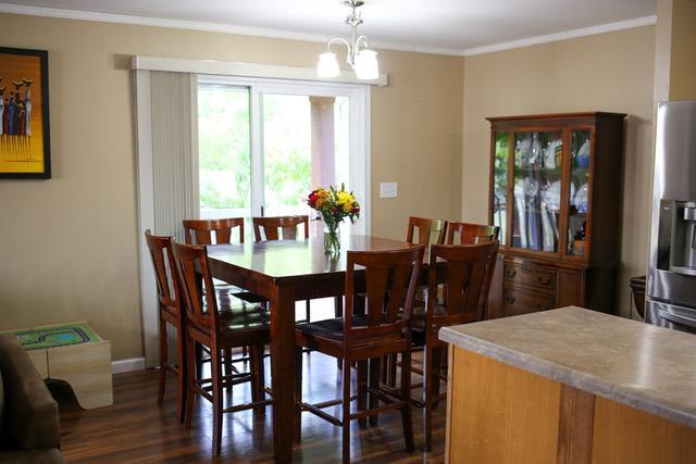 dining area featuring ornamental molding, an inviting chandelier, and dark hardwood / wood-style floors