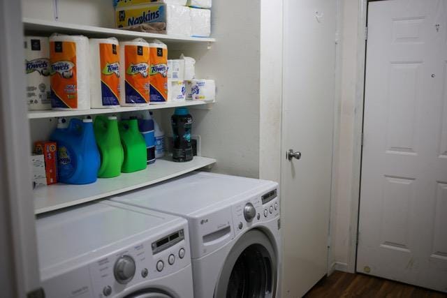 laundry room featuring dark wood-type flooring and washer and clothes dryer