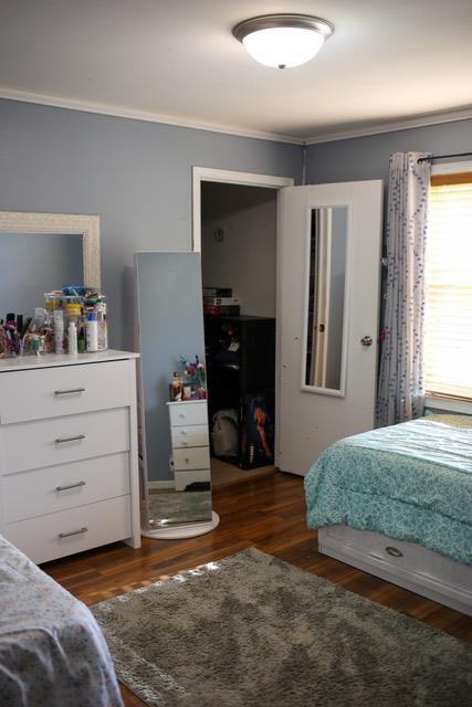 bedroom featuring crown molding and dark hardwood / wood-style floors