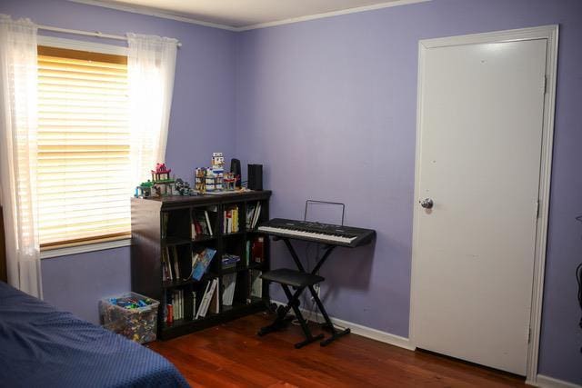 interior space featuring dark wood-type flooring and ornamental molding