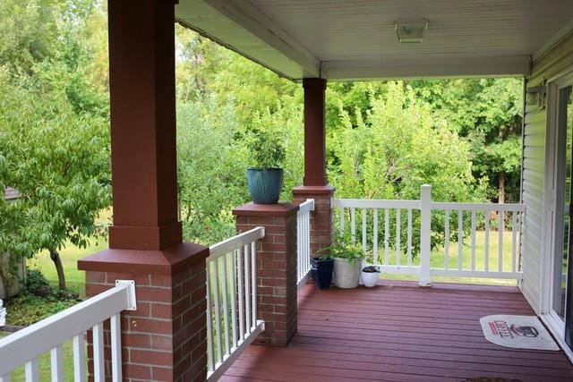 wooden terrace featuring covered porch