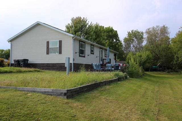 view of property exterior featuring a lawn