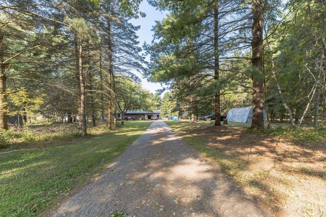 manufactured / mobile home featuring a front yard and a wooden deck