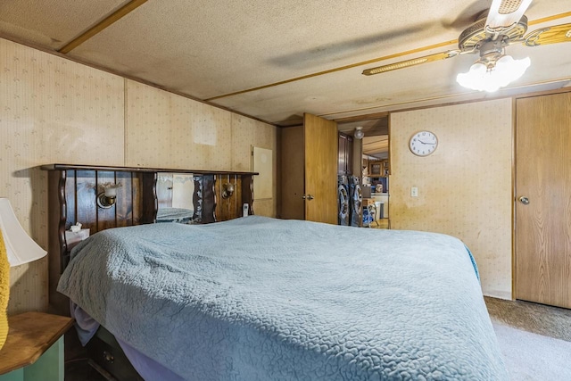 carpeted bedroom with ceiling fan and a textured ceiling