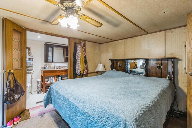 carpeted bedroom featuring a textured ceiling and ceiling fan