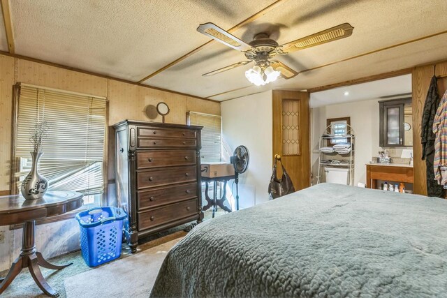 carpeted bedroom with a textured ceiling and ceiling fan