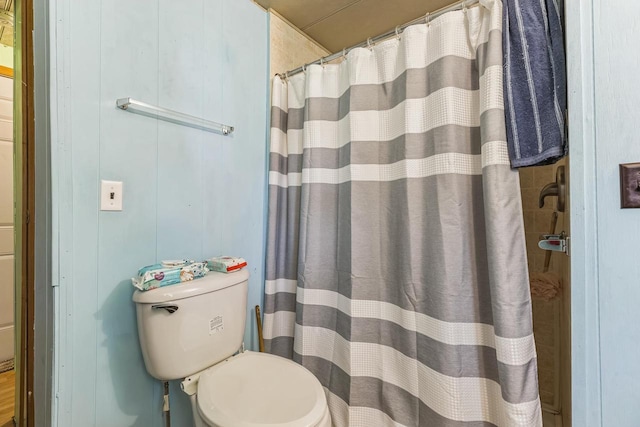 bathroom featuring toilet and walk in shower