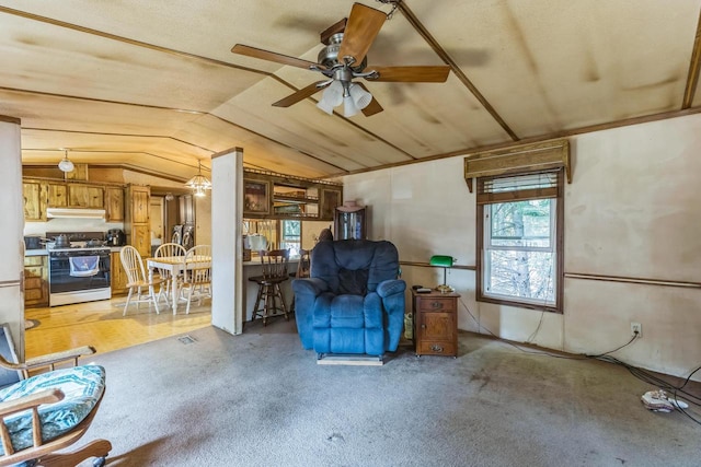 living area featuring light colored carpet, ceiling fan, and vaulted ceiling